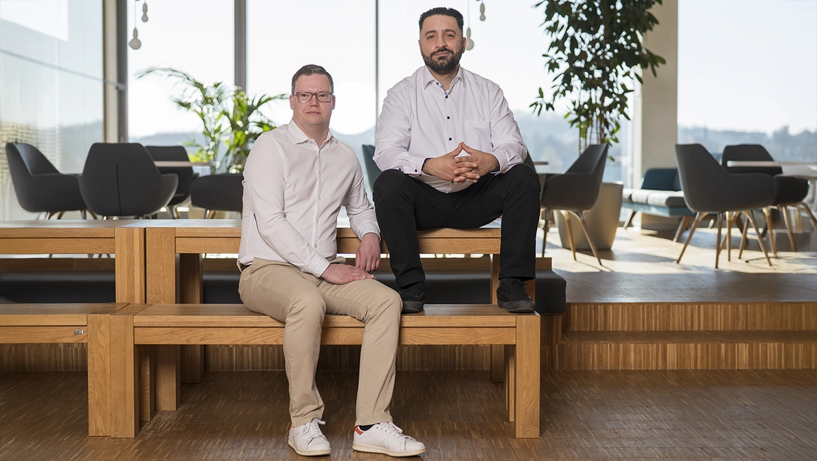 KOMSA Services contact persons Two business men sitting on bench at KOMSA cafetaria