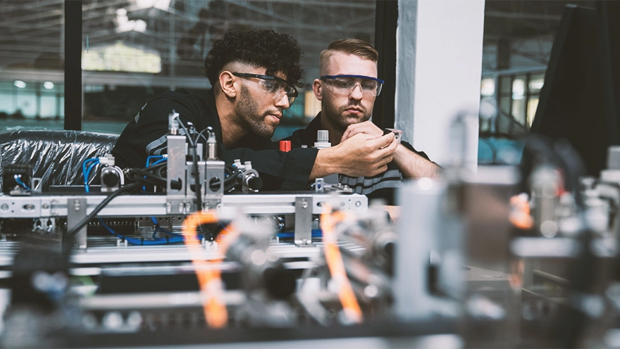 two people doing technical support surrounded by technical equipment two people doing technical support surrounded by technical equipment